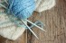 balls of yarn and mittens on a wooden background